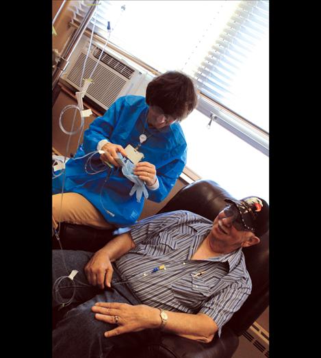 Patient Roy Mathis smiles as Nurse Lisa Bertoglio starts him on his chemotherapy recipe. Mathis has lung cancer and visits the oncology clinic weekly.