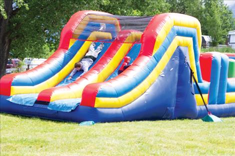 A silent auction was also held to raise funds for the fire department and a bounce house slide (lower left) set up for children to play on.