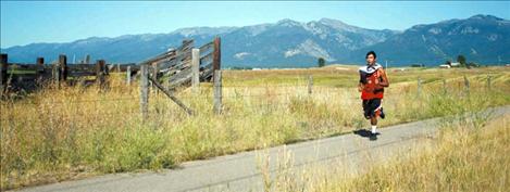 Zachary Wagner runs the cross-country team’s first leg along Round Butte Road