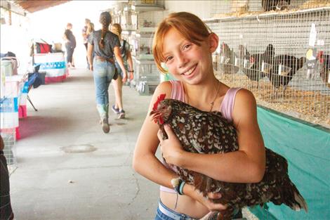 Reagan Reash hugs her hen “Speckles.”