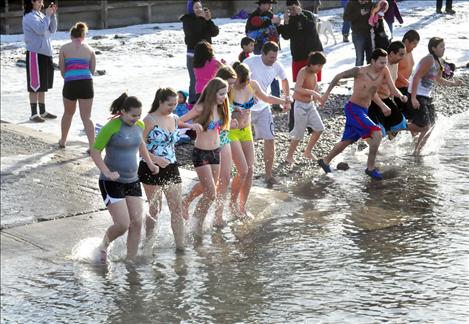 Right at 1 p.m. on Jan. 1, a group of teens head in feet first.