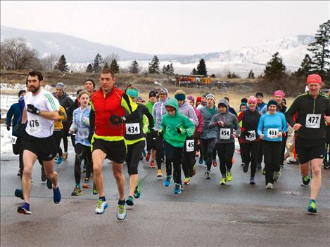 Fifty-one runners head off at the start of the race to complete a 13.1-mile loop around Polson, despite Saturday’s high winds and drenching rains. 