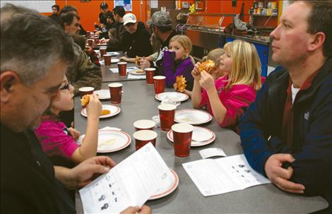 Dads share pizza with their children at Linderman Elementary School in Polson.