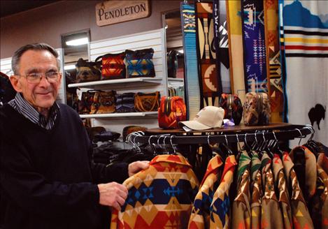 Jim Duford straightens Pendleton jackets at the First Resort. The store carries a large Pendleton collection, and Duford received a plaque honoring his 50-year history with Pendleton Woolen Mills. 