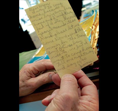 Jim Duford holds a postcard he sent to his mother soon after he came to Polson in 1946 to live with his Aunt Irene and Uncle Les Baldwin. Duford’s mother saved the heart-wrenching message.