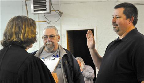 Roger Lemon, left, and Daren Incashola are sworn in as councilmembers for the St. Ignatius Town Council.