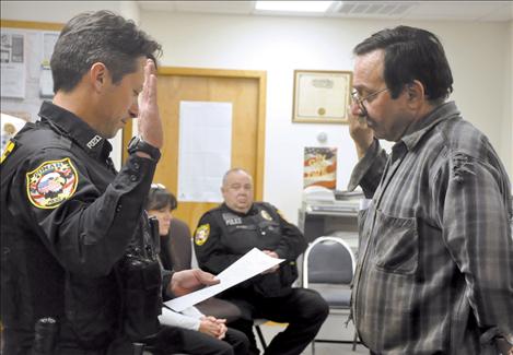 Mayor Kim Aipperspach, right, swears in Timothy Case as a Ronan police officer.  