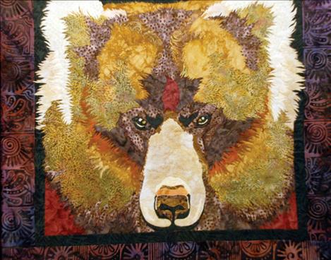 The grizzly bear’s eyes seem to follow people who come to look at this quilt.