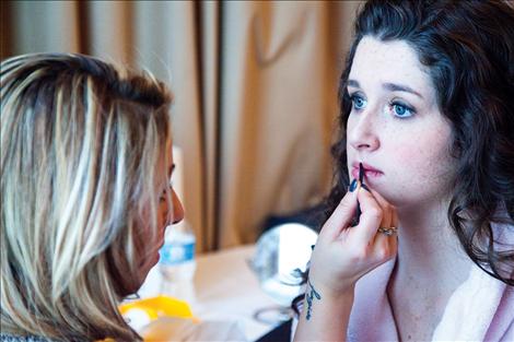 Shauna Johnson applies makeup to model Kaelyn Binder.