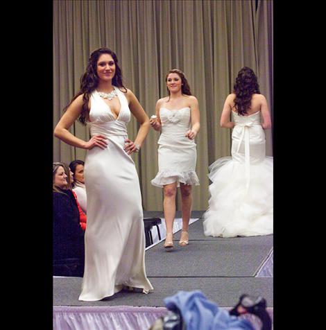 Kacie Busby and Jessica Bagnell model wedding gowns.