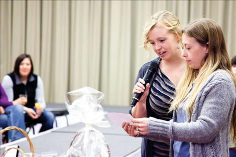 Bridal fair organizers Summer Goddard, left, and Darlene Beeks announce winners of prize baskets.