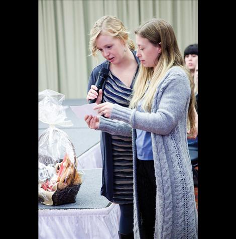 Bridal fair organizers Summer Goddard, left, and Darlene Beeks announce winners of prize baskets.