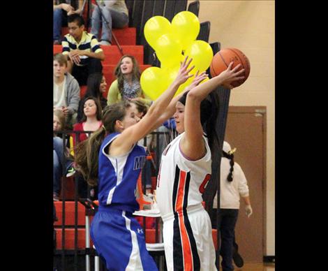 Ronan Maiden Malia Hamel, right, is defended by Mission Lady Bulldog Kaylie Durglo during Ronan's Friday, Jan. 17 game against Mission.