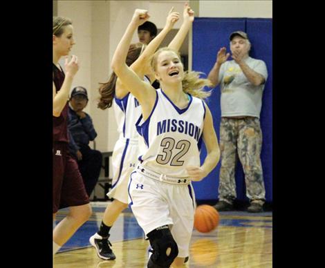 Lady Bulldog Carley Elverud celebrates with her teammates  after Mission captured their first win of the season against Troy, 38-34.