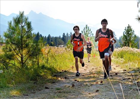 Jaden McNair, left, and Zach Wagner run neck-and-neck during the Ronan Canal Bank Run. McNair finished in 19:57, just behind Wagner’s 19:16.