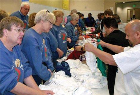 Volunteers work on floats in Pasadena, Calif., in preparation for the 2014 Tournament of Roses Parade.