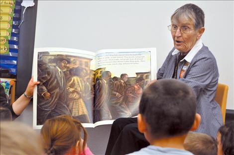 Rita Gergorich reads a story about Martin Luther King, Jr. to students at K. William Harvey Elementary School. 