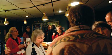 Attendees enjoy wine, cheese, coffee and cheesecake after the FLIC awards were announced.