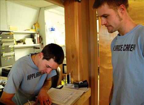 Appliance Care owners Caleb, left, and Sam Allred work on the day’s schedule of service calls.