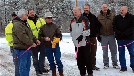 Confederated Salish and Kootenai Tribal Councilman Leonard Gray, center, cut the ribbon on the new Michel Bridge. Also at the ceremony were Lake County Commission Bill Barron, left, Rick Kerr, Lake County Bridge Foreman, Richard Jackson, Lake County Bridge Department, Lake County Commissioner Gale Decker, Jay Garrick, Lake County Road Superintendent, Mike Brown, CSKT Roads Program Manager, and Mike Jensen, architect.