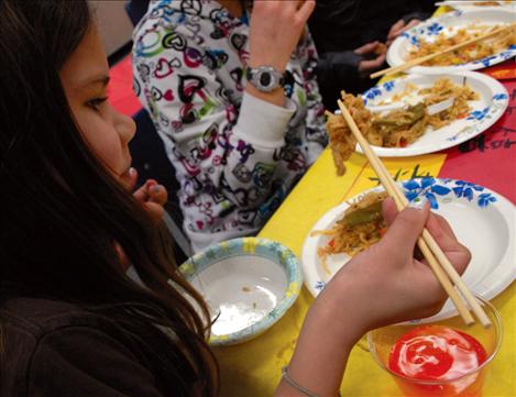 Kyleigh Nichols struggles with her chopsticks during the Chinese lunch.