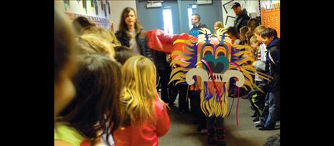 Underneath that dragon’s colorful head and long red body are Mrs. Lozar’s fourth grade class moving the dragon.