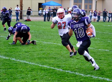 Viking junior Tyler Delaney breaks a tackle attempt as he races down the field in Friday’s 59-28  win over Darby.