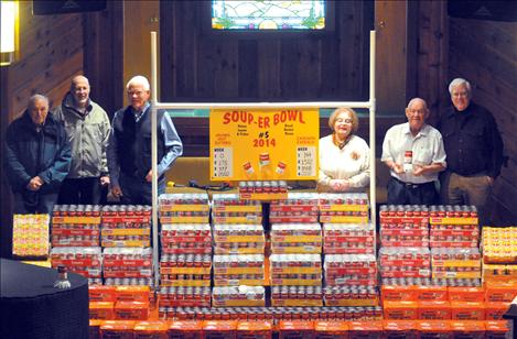 Merle Parise, Bryan River, Bill Smith, Sherri McDonald, Dale Jackson and Russ Jenkins stand with 4,004 units of soup that will be given to the Polson Loaves and Fish and Ronan Bread Basket food pantries. 