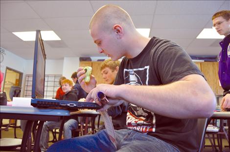 Rocco Santorno works on his math-riddled love poem to a friend.