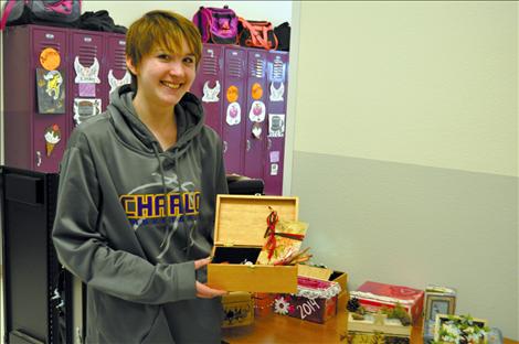 Charlo student Katie Revis holds a reflection box.