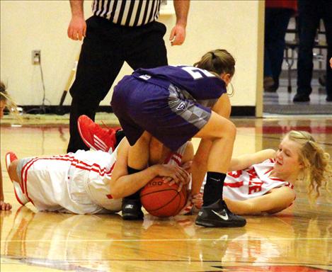 Morgan Malatare, Jordan Ludeman and Carly Hergett, from left,  scramble to gain  possession  of the ball.