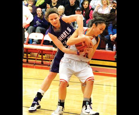  Lady Viking Aspen Runkel struggles to retrieve  the ball from Scarlet  Violet Pablo.