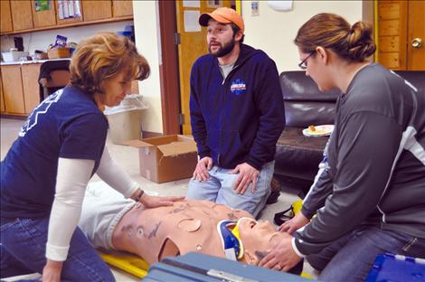 Valerie Umphrey, left, trains with younger EMTs Joe Mitchell and Annie Morigeau. 