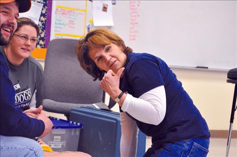 Valerie Umphrey, Annie Morigeau and Joe Mitchell communicate in a training exercise.