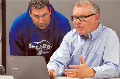 St. Ignatius technology coordinator Matthew Lyon demonstrates the capabilities of a Google Chromebook for school board member Jeff Evans. 