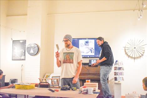 Artist Sean Parson holds up a tool that will be used during the mosaic tile workshop.