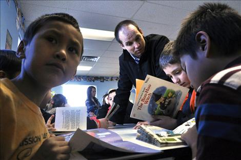 Aric Cooksley visits with students during an academic power hour at the Boys and Girls Club in Ronan.