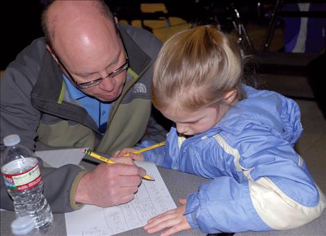 Dad Gary Collinge and daughter Lauren add numbers while playing a game of bacon. 