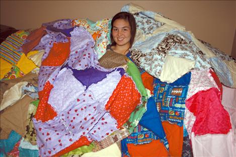 McKalistar Rosenbaum is buried beneath a mountain of blankets she quilted for cancer patients.