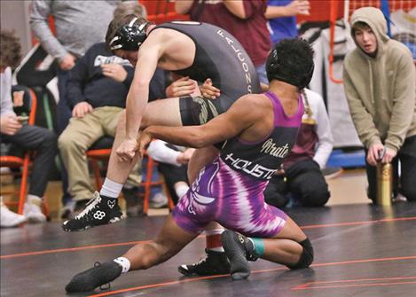 Polson’s Gabe Houston throws a Hamilton Bronc’s wrestler during a Jan. 3 match.