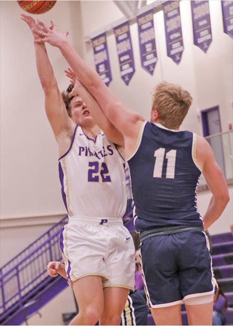 Pirate basketball player Maddox Bird shoots over Dillon player Kyler Engellant.