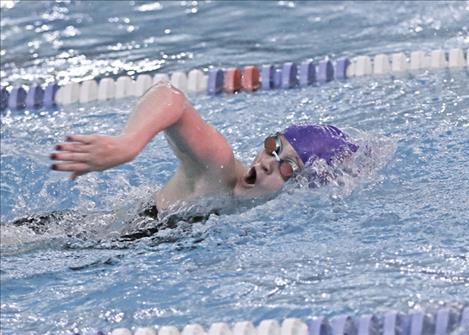 Polson swimmer Dixie Montgomery competes in the 400M Freestyle Relay during the Jan. 10 Polson Invite at Mission Valley Aquatics. Right: Polson’s Teague McElwee enters the pool in the boys 400M Freestyle Relay.
