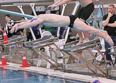 Polson’s Teague McElwee enters the pool in the boys 400M Freestyle Relay.