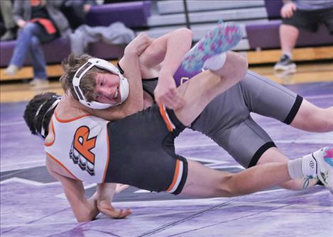 Polson wrestler Jaspin Fisher takes down his opponent in the 144 weight category. 