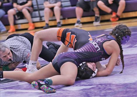 Polson Lady Pirate wrestler Gracie Hammer wins with a pin in the 115 category.