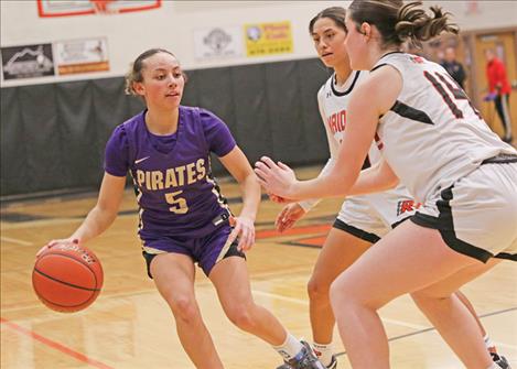  Polson Pirate Rylee Taylor-Jefferson draws two Ronan players.