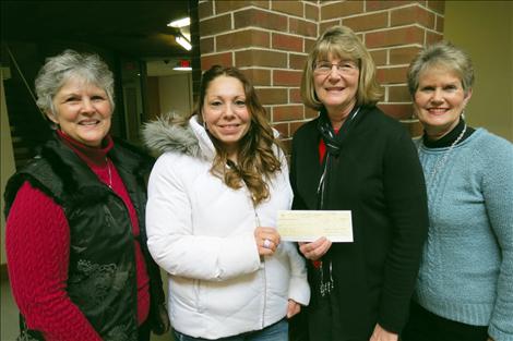 P.E.O. Chapter BY Program for Continuing Education Grant Committee members gather to present an $1,800 grant check to Melinda Ann Kline. Pictured from left are Toni Young, Kline, Jeanne Doepke and Cheryl Thomas.