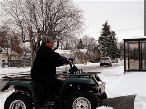 Sonny Martinez plows a parking lot.