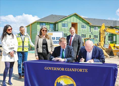 Gov. Gianforte (right) signs House Bill 210 with Secretary Jacobsen, Bob Heberly, Commissioner Swanson, Rep. Fitzpatrick, and Rep Buttrey (from left to right).