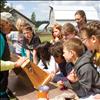 Local beekeeper Carey Swanberg shows students bees from her hives and let them sample some honey they made.